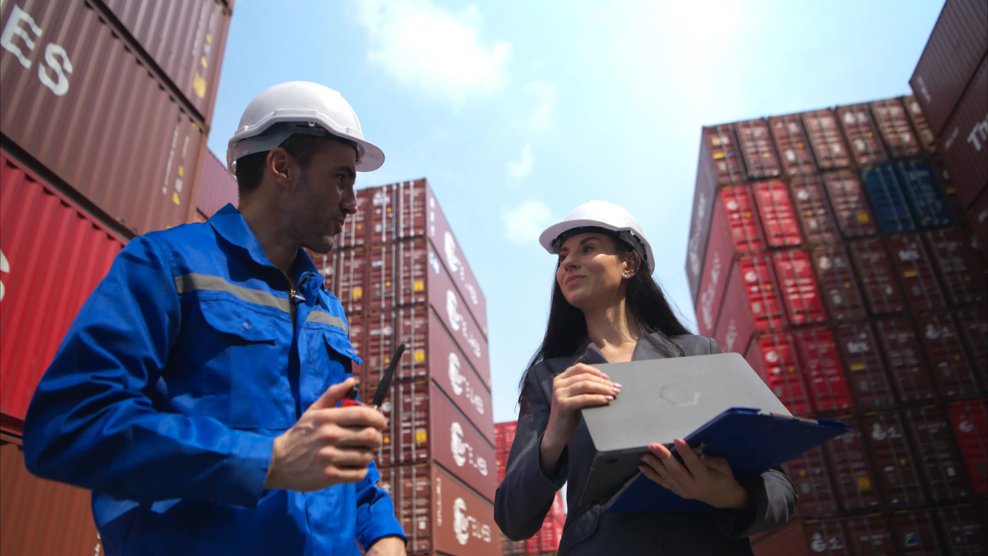 A container manufacturing manager and businesswomen inspect the area to plan the storage.