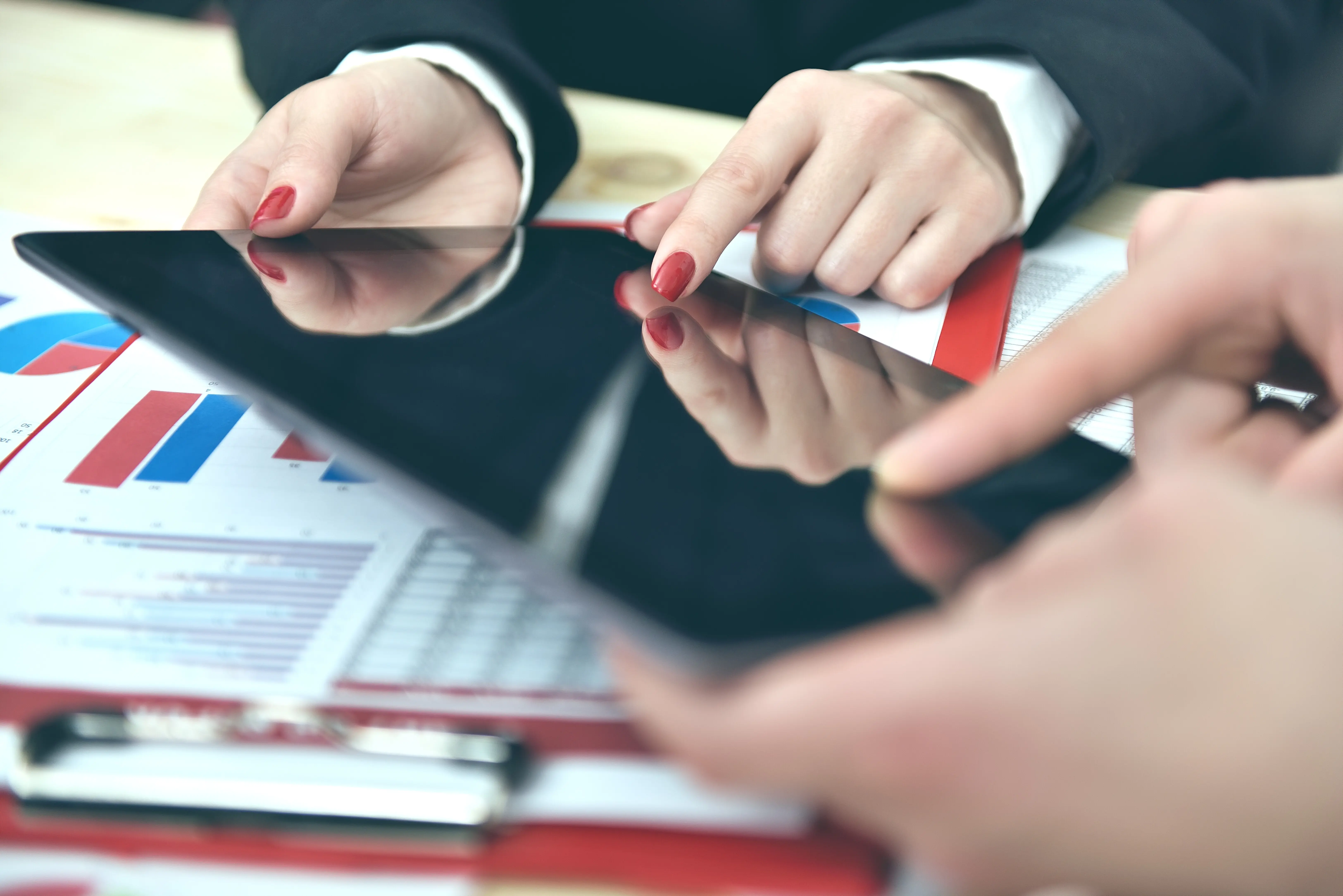 Hands of coworkers during a data discussion.