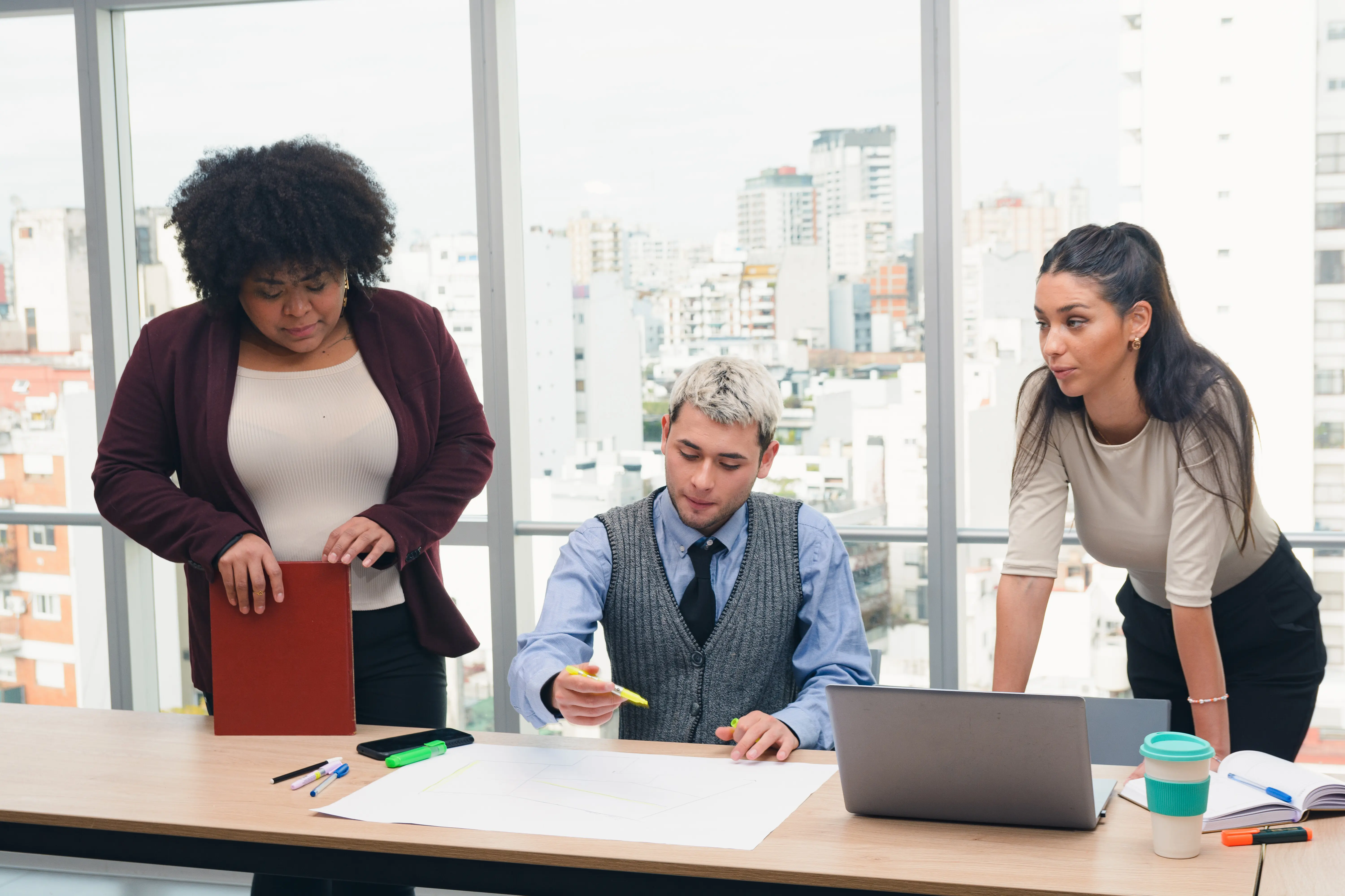People working in a coworking space creating strategic business plans and routes